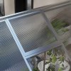 Outsunny 6 x 10ft Polycarbonate Greenhouse with Rain Gutters, Large Walk-In Green House with Door and Window, Garden Plants Grow House with Aluminium Frame and Foundation